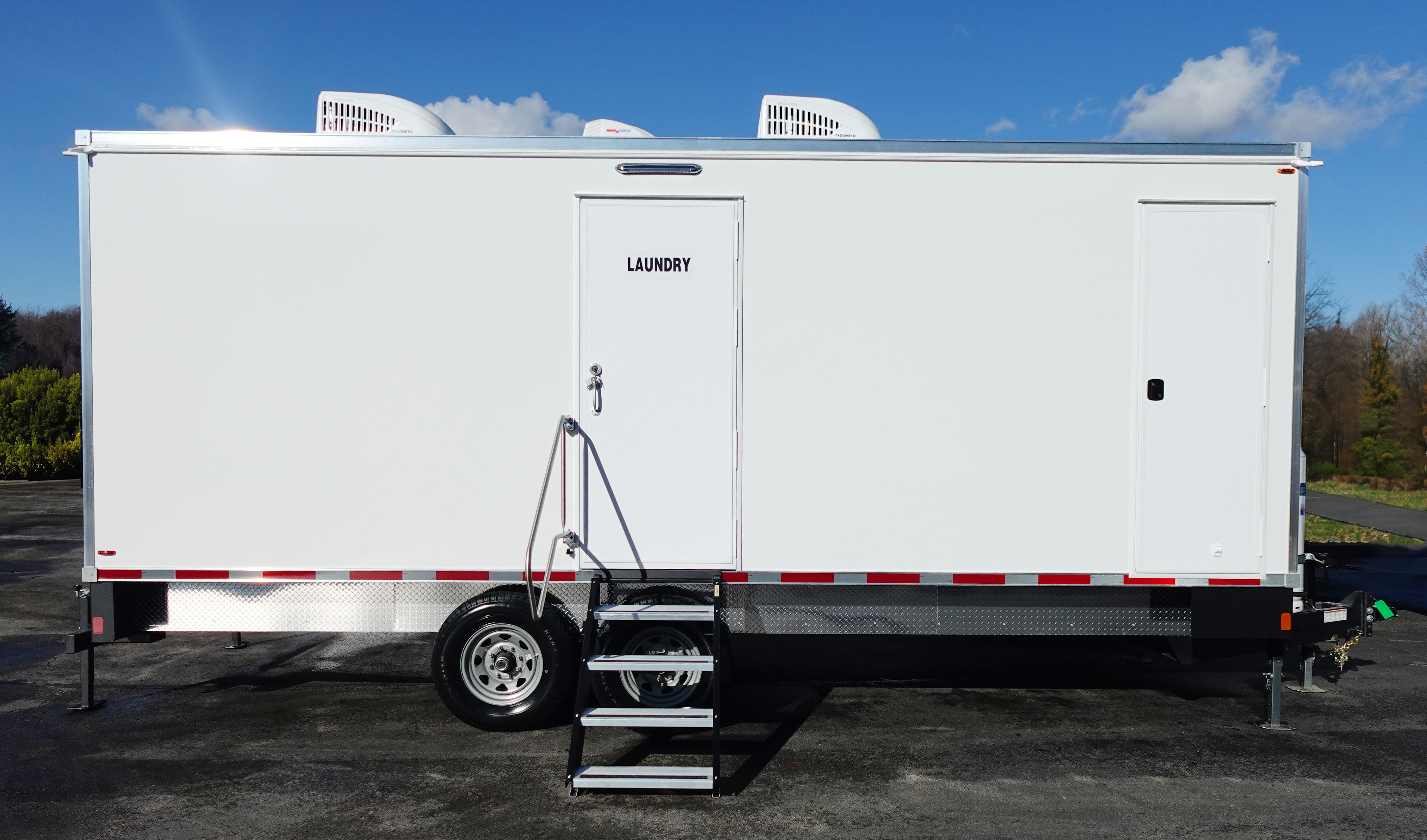 8 station mobile laundry trailer rental Texas. Eight industrial Whirlpool washer dryer units for disaster relief and workforce camps